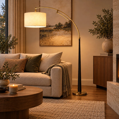 Arc floor lamp with drum shade beside living-room seating