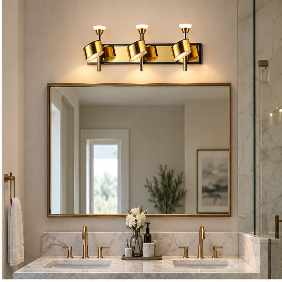 Gold three-head adjustable wall light above a bathroom mirror