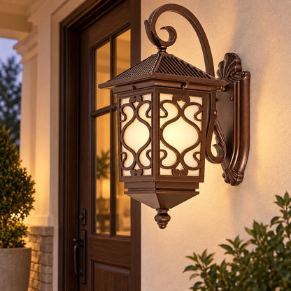 Ornate scrollwork wall lantern beside a covered entry door