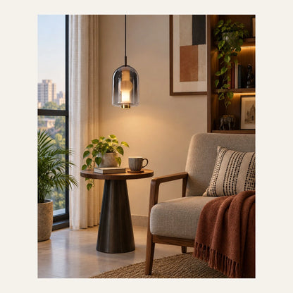 Smoke capsule glass pendant above a reading corner