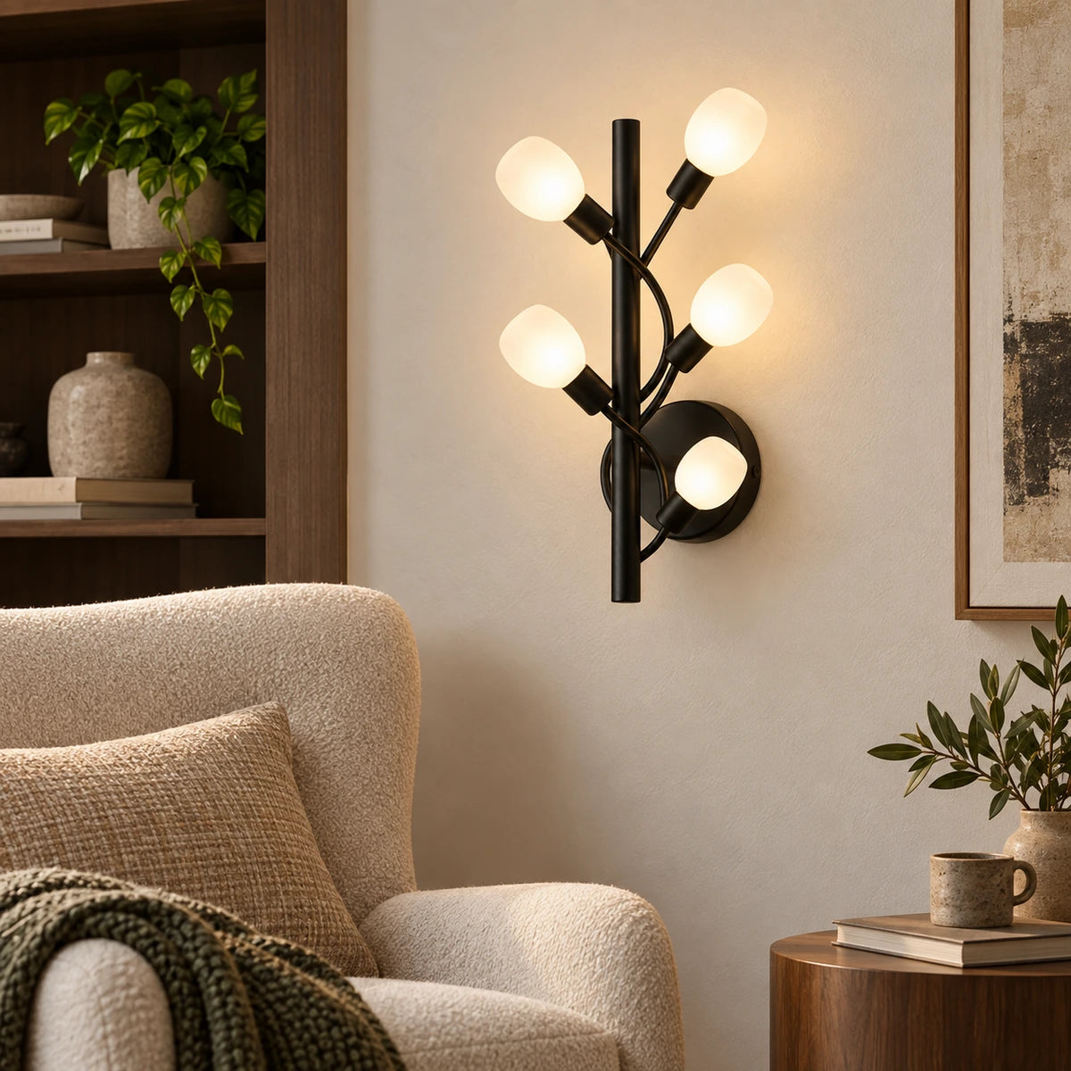 Five-globe black branch wall sconce in a reading corner