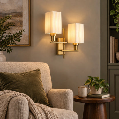 Twin pleated shade wall sconce in a reading corner