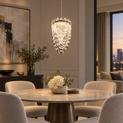 Single-drop faceted crystal pendant above a round dining table