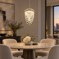 Single-drop faceted crystal pendant above a round dining table