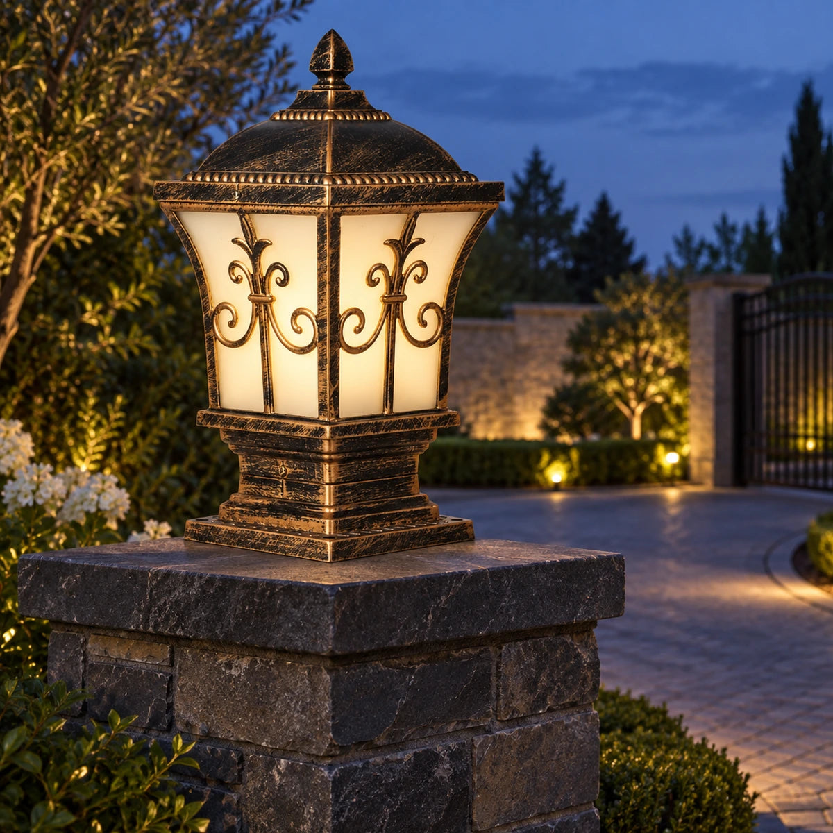 Ornate frosted panel pillar light on a dark stone gate pillar