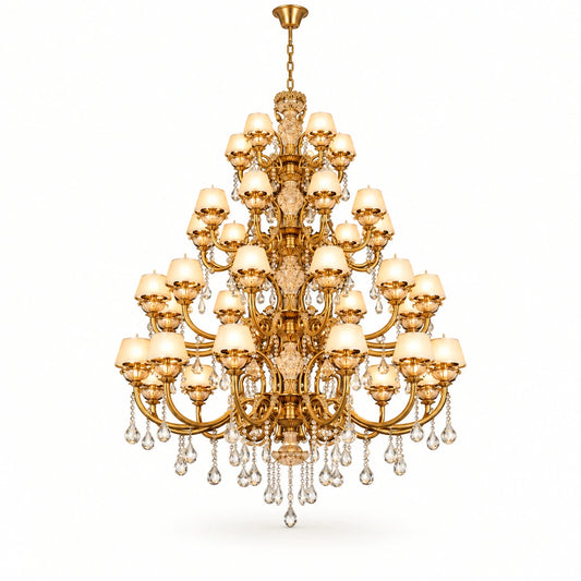 Monumental multi-tier antique gold crystal chandelier on a warm-white background