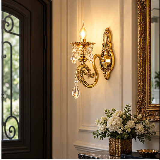 Antique gold crystal wall light in an entryway