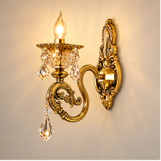 Antique gold single-arm crystal wall light on warm white