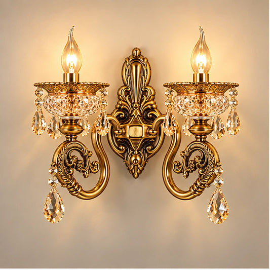 Antique gold two-arm crystal wall light on warm white
