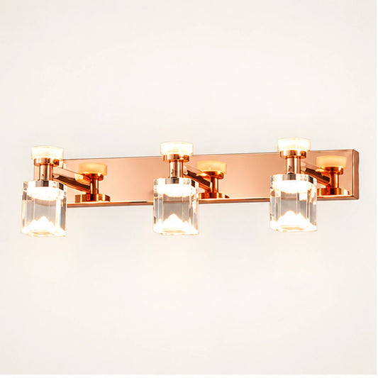 Rose gold three-cube vanity light on warm white