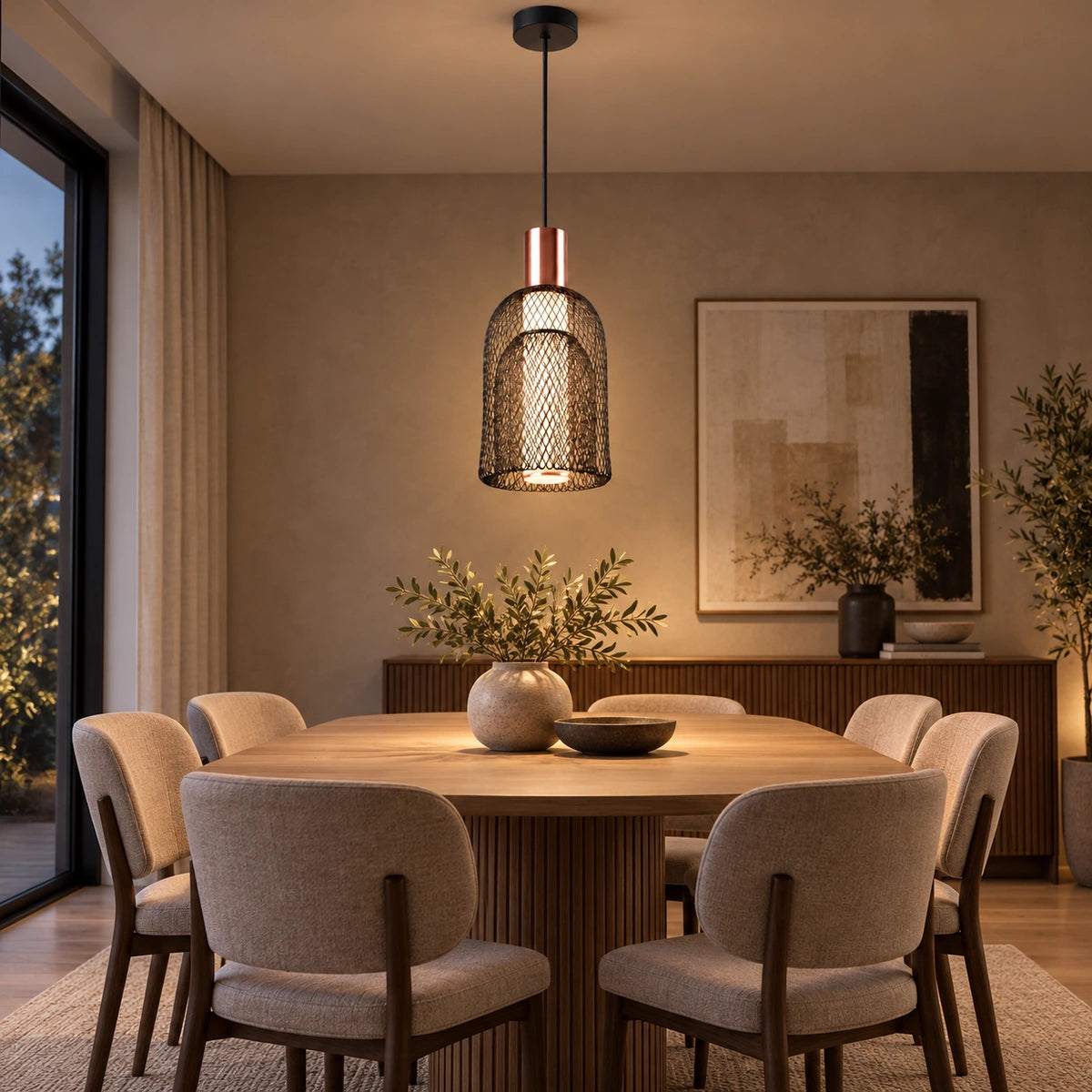 Nested black mesh pendant light over a dining table