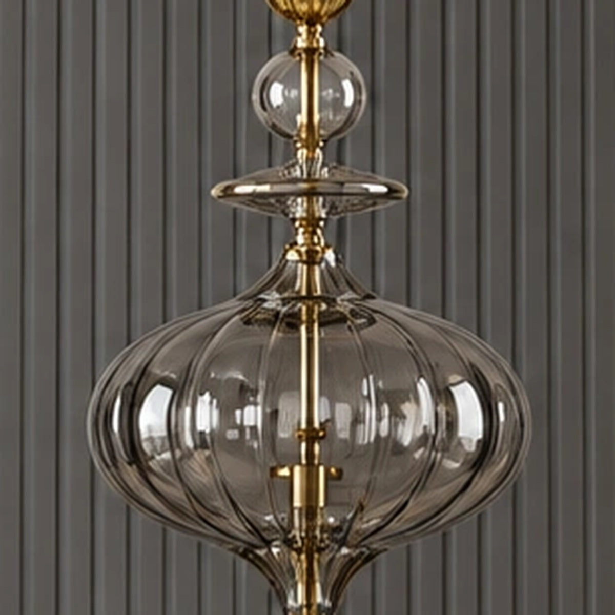 Close-up of the lobed smoke-glass body and gold centre stem
