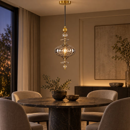Ornate smoke-glass and gold pendant above a round dining table