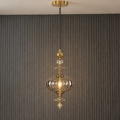 Ornate smoke-glass and gold pendant illuminated in a contemporary room