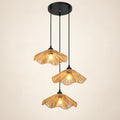 Lotus weave three-light pendant cluster on a warm studio background