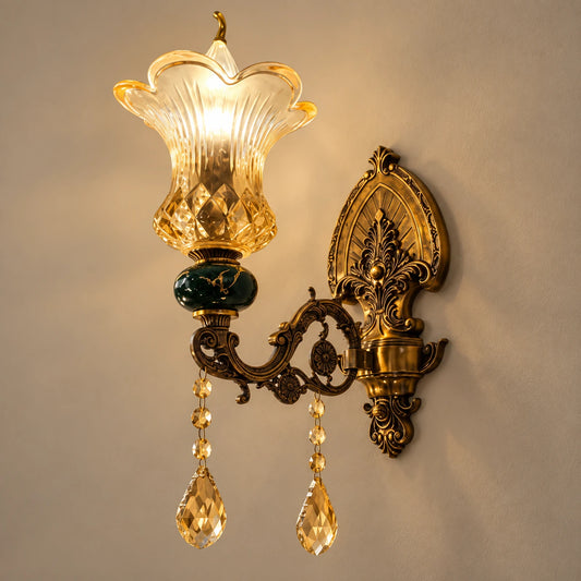 Green and amber floral glass wall sconce on a warm studio wall