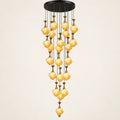 Amber glass double-height cluster chandelier on a warm studio background