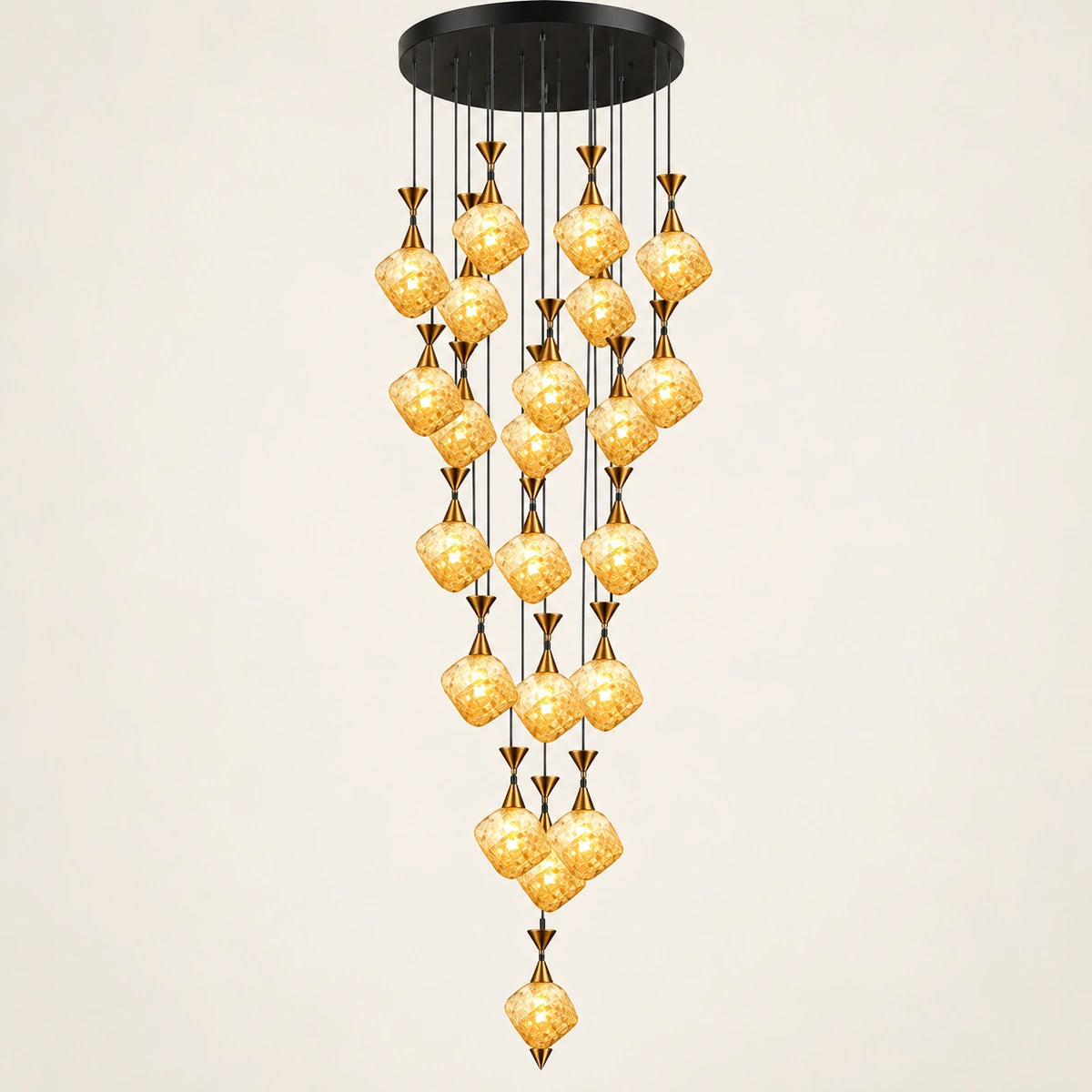 Amber glass double-height cluster chandelier on a warm studio background