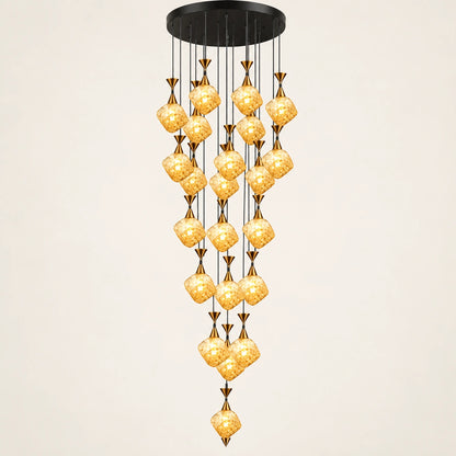 Amber glass double-height cluster chandelier on a warm studio background