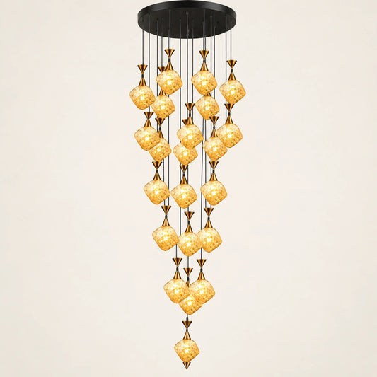 Amber glass double-height cluster chandelier on a warm studio background
