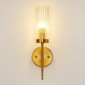 Tall ribbed glass cylinder wall sconce with brass-tone mount