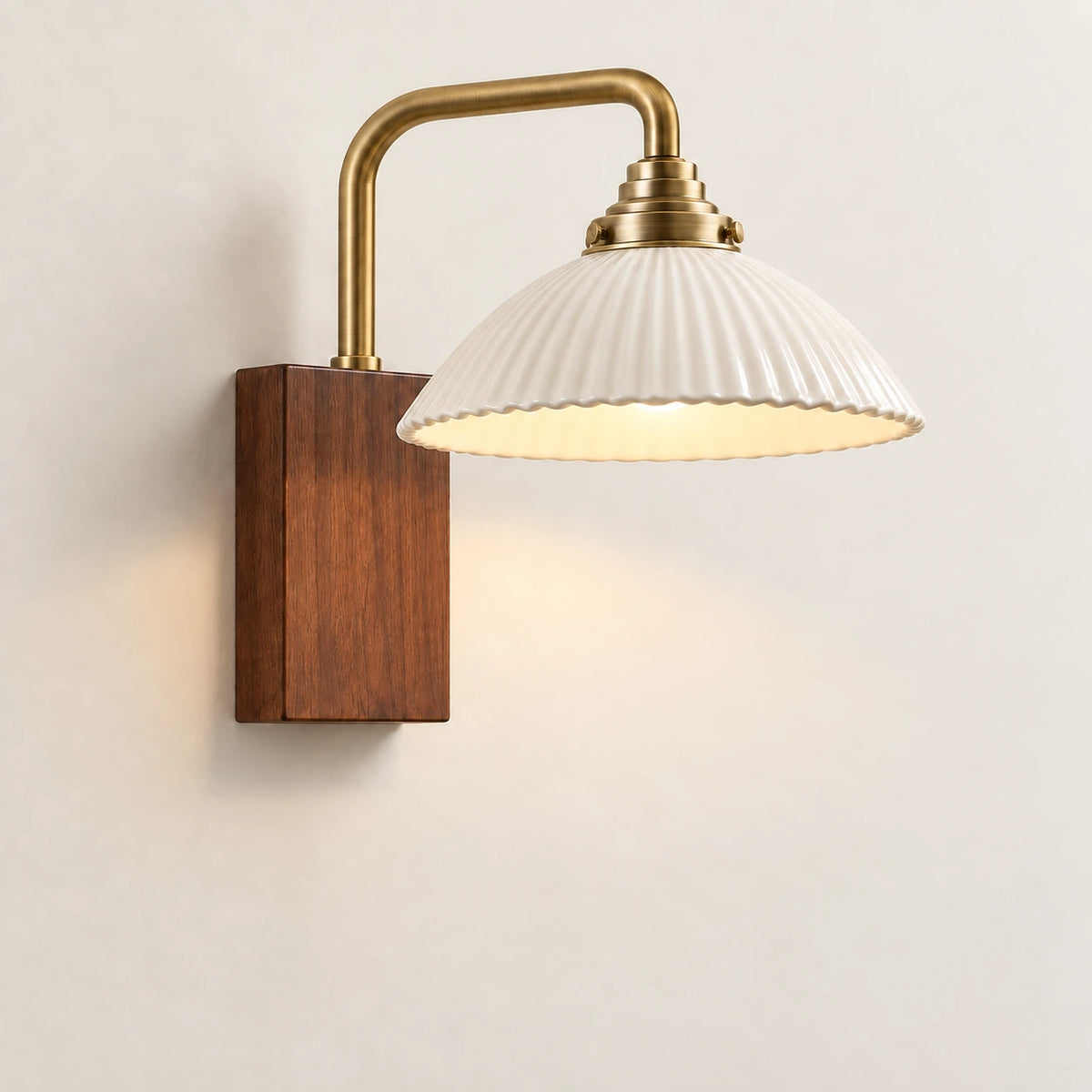 Ceramic dome reading wall sconce on a warm studio wall