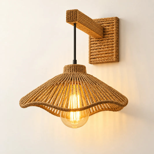 Woven bell shade wall sconce on a warm studio wall