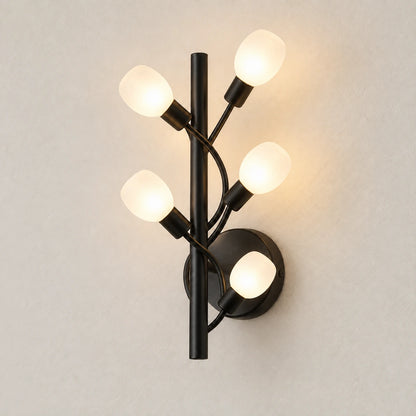 Five-globe black branch wall sconce on a warm studio wall