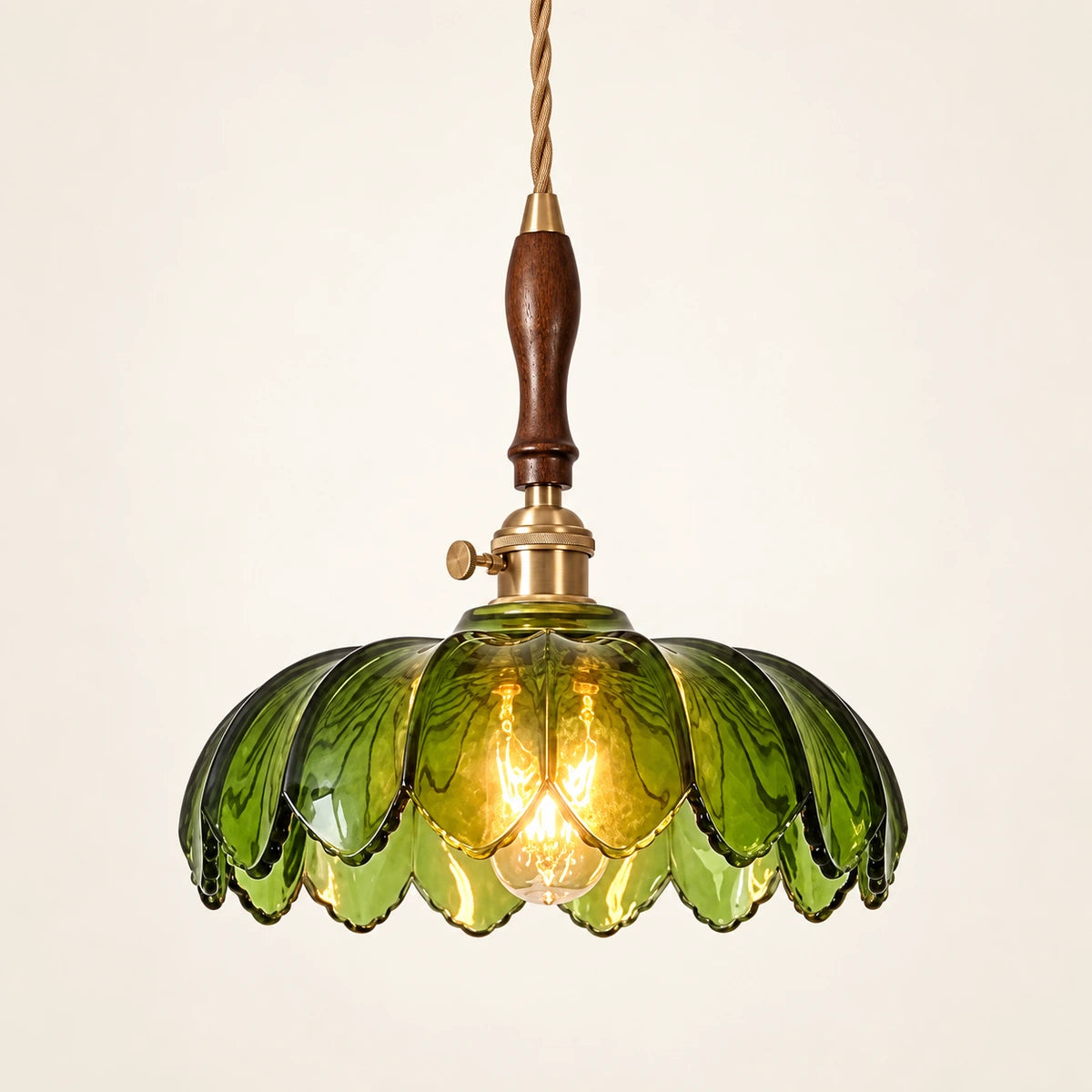 Green petal glass pendant on a warm studio background
