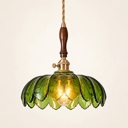 Green petal glass pendant on a warm studio background