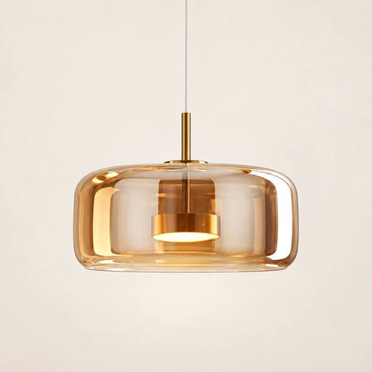 Amber glass capsule pendant in warm brass tone