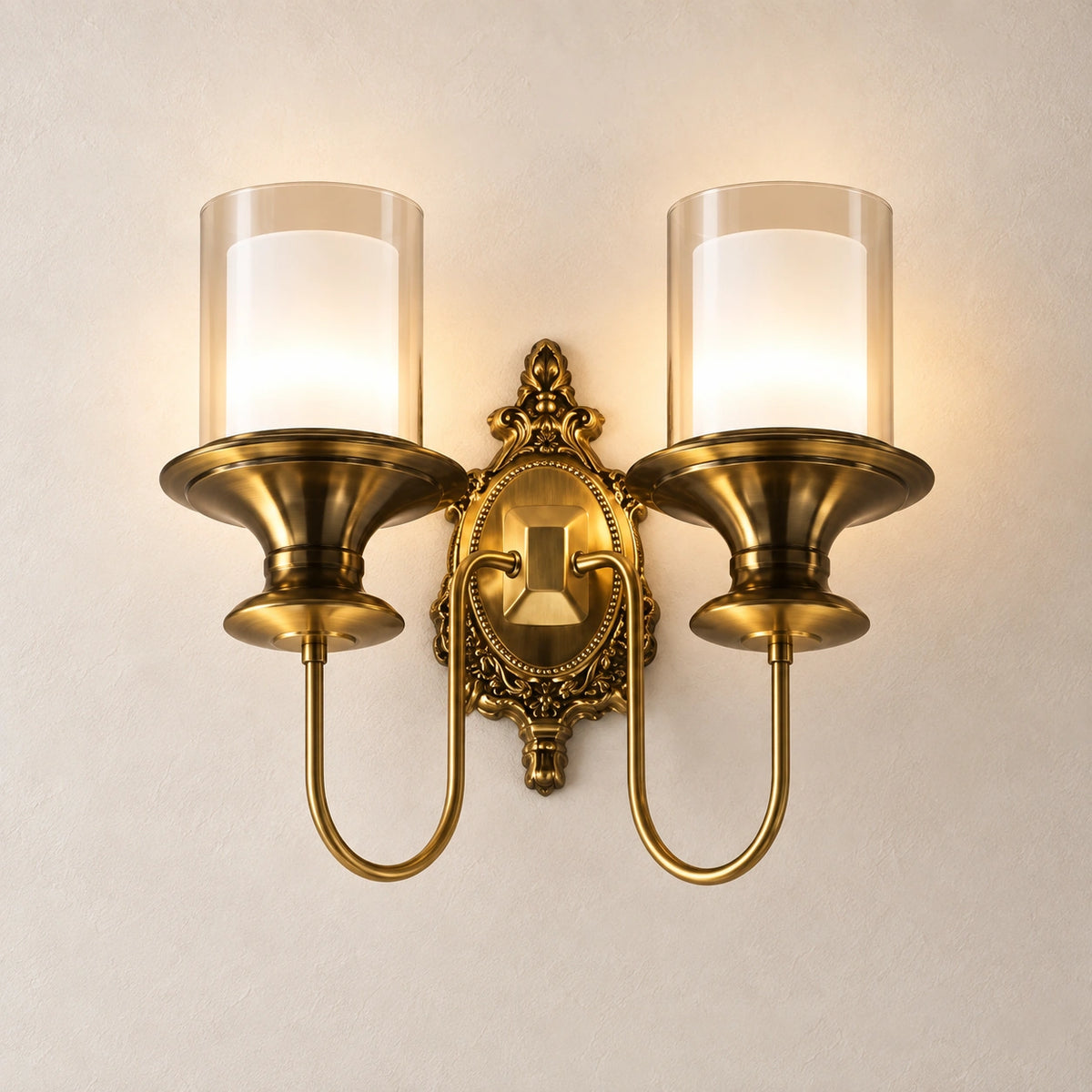 Ornate twin-cylinder wall sconce on a warm studio wall