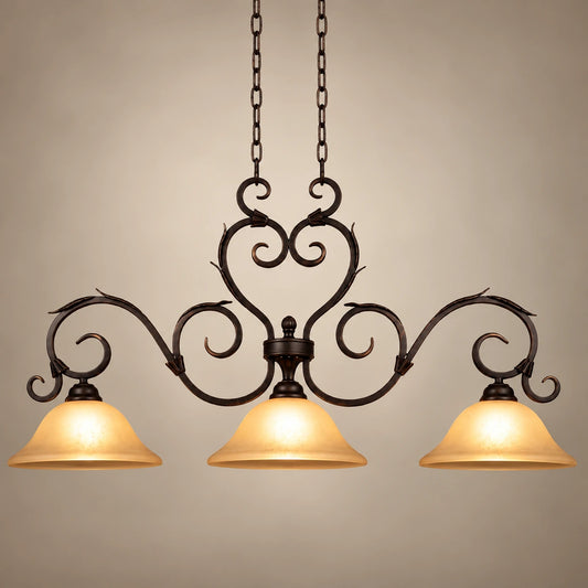 Antique-scroll three-shade linear pendant on a warm studio background