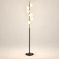 Milky globe column floor lamp on a warm studio background