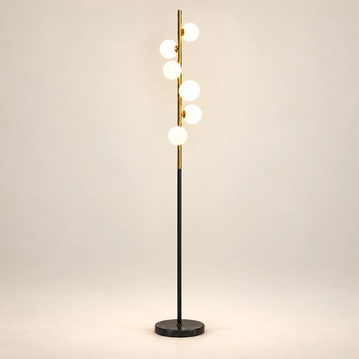 Milky globe column floor lamp on a warm studio background
