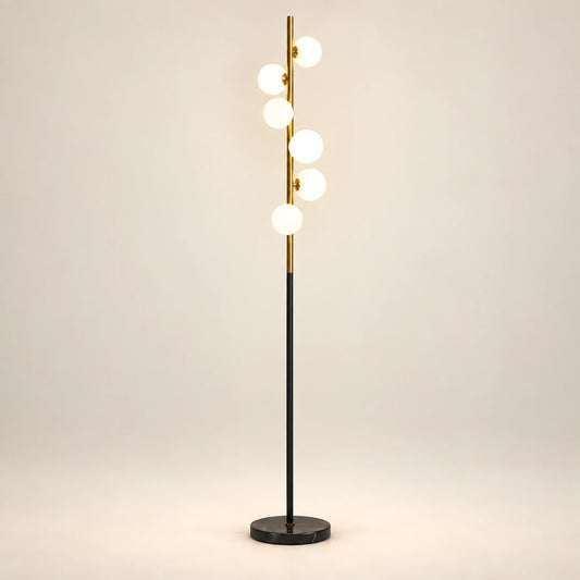 Milky globe column floor lamp on a warm studio background
