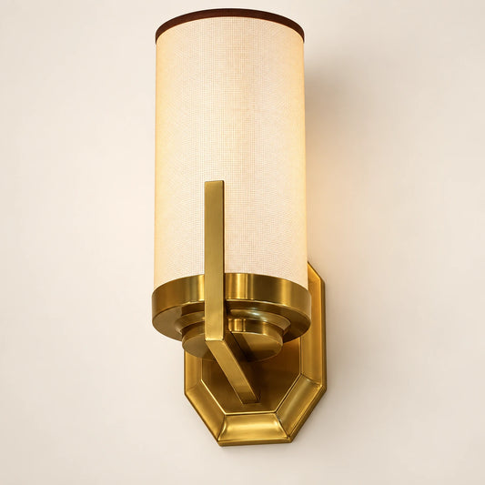Tall cylinder shade wall sconce with faceted brass-tone mount