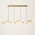 Sculptural wave LED chandelier on a warm studio background