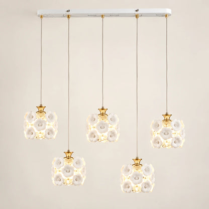 Floral ceramic five-shade pendant cluster on a warm studio background