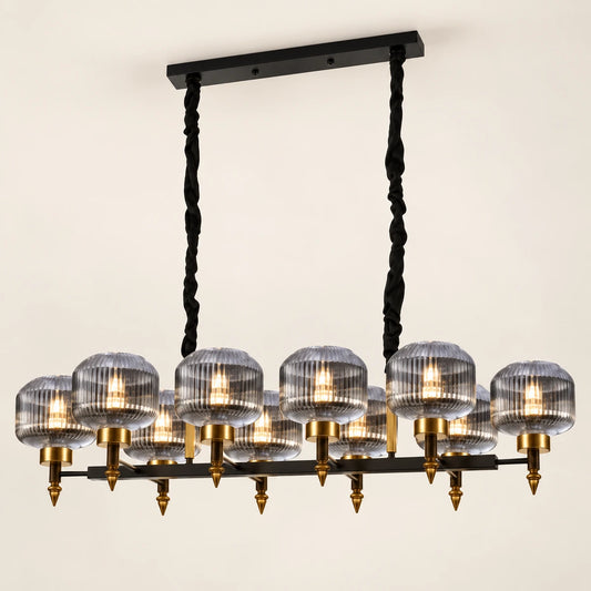 Smoke-glass ten-light linear pendant on a warm studio background