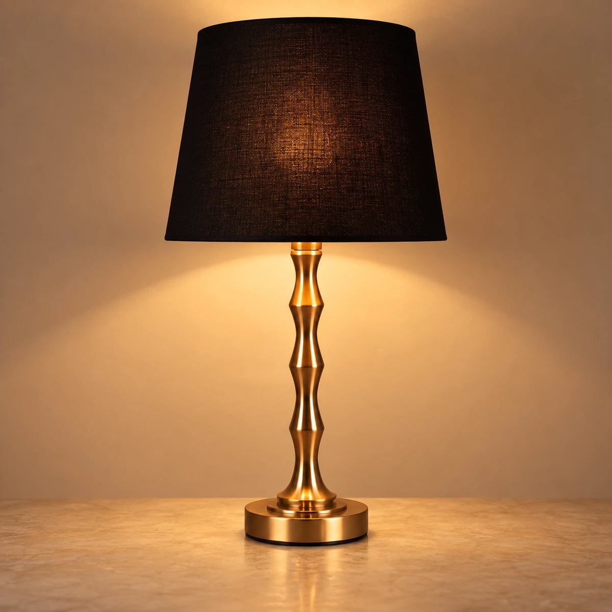 Copper-tone sculptural table lamp with black shade