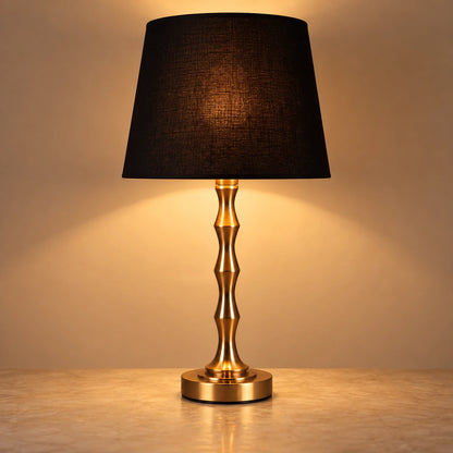 Copper-tone sculptural table lamp with black shade