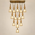 Thirteen-light amber glass cascade chandelier on a warm studio background