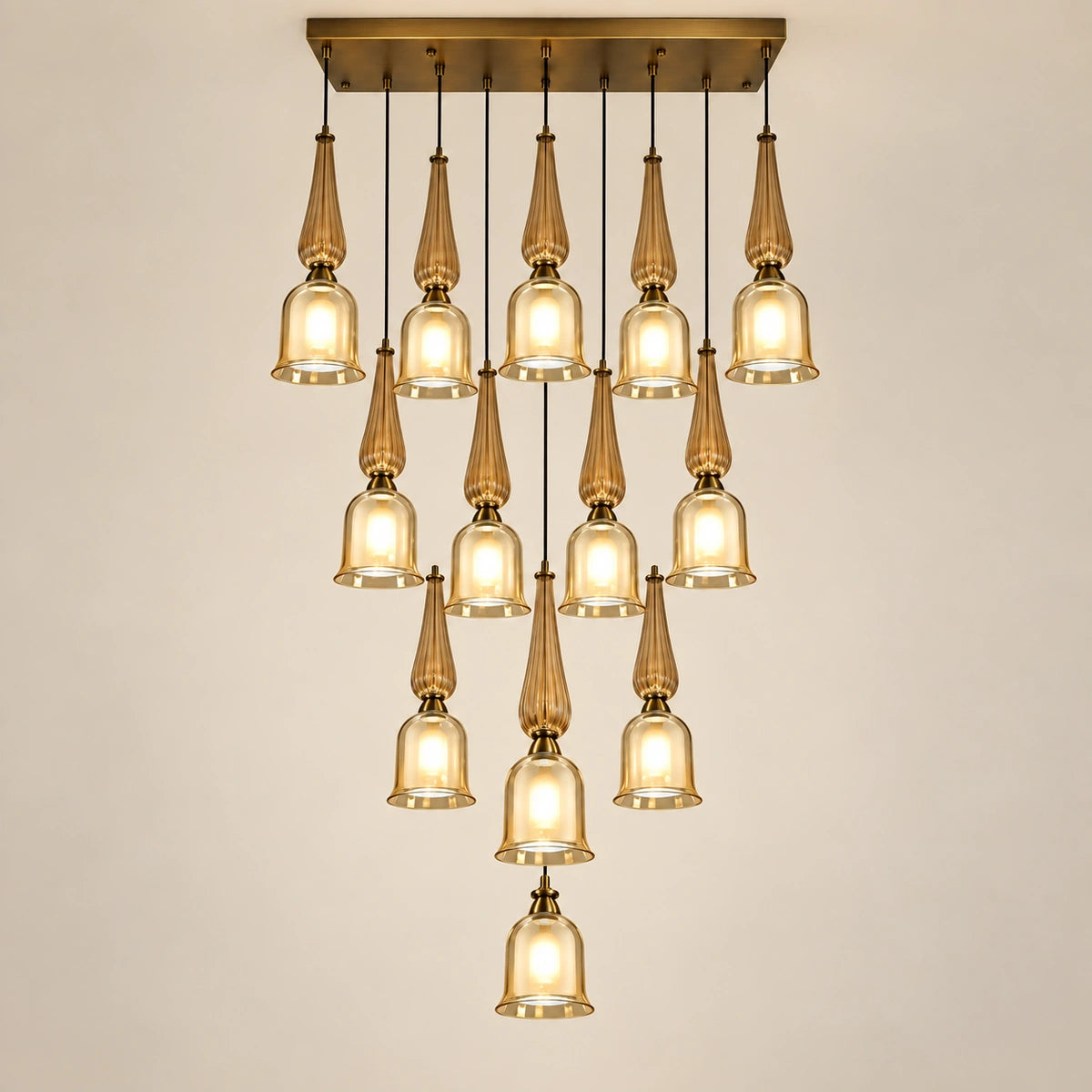 Thirteen-light amber glass cascade chandelier on a warm studio background