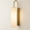 Tall cylinder shade wall sconce in ivory and warm brass tone
