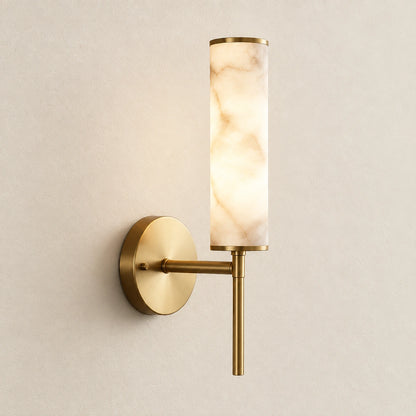 Alabaster-look cylinder wall sconce on a warm studio wall