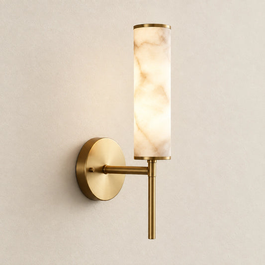 Alabaster-look cylinder wall sconce on a warm studio wall
