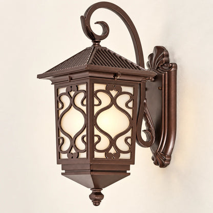 Ornate scrollwork wall lantern in antique bronze tone