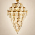 Grand frosted leaf double-height chandelier on a warm studio background