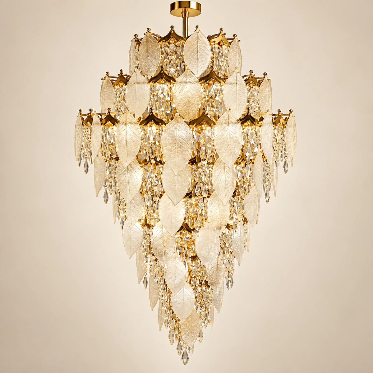 Grand frosted leaf double-height chandelier on a warm studio background